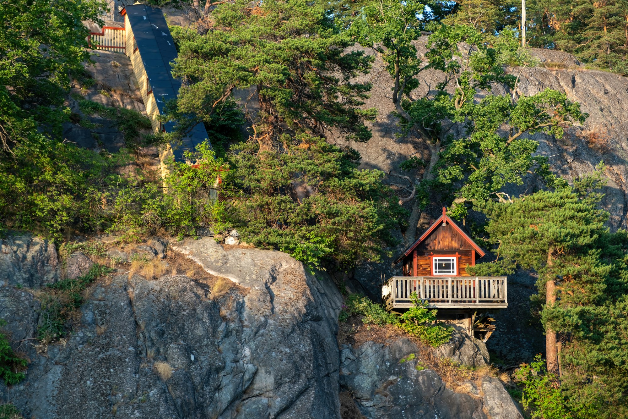 stockholm-sweden-archipelago-cottage-with-balcony-built-on-rock-between-lush-nature-background.jpg